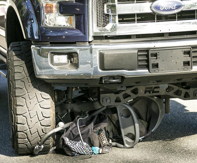 A baby stroller lies crushed under a pickup truck at the corner of Southeast 22nd Avenue and Southeast 17th Street in Ocala on Wednesday afternoon. The driver of the truck apparently did not see the mother pushing the stroller. The toddler received minor cuts and abrasions. [Doug Engle/Staff photographer]