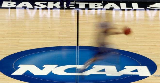 In this March 14, 2012, file photo, a player runs across the NCAA logo during practice in Pittsburgh. (AP Photo/Keith Srakocic, File)