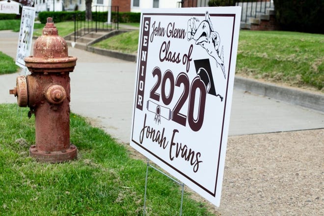 Signs recognizing the John Glenn class of 2020 line Main Street in New Concord.