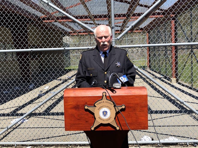 Sheriff Thomas Hodgson speaks at a podium placed in in front of Unit B outdoor recreation area that reportedly held 26 inmates at the time of the incident Friday. [TIM DUNN/THE STANDARD-TIMES SPECIAL]