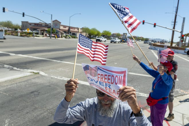 Robert Bithron demonstrates with a group at Apple Valley and Bear Valley roads in Apple Valley on Saturday, May 2, 2020. The group is seeking the reopening of California’s businesses. [JAMES QUIGG FOR THE DAILY PRESS]