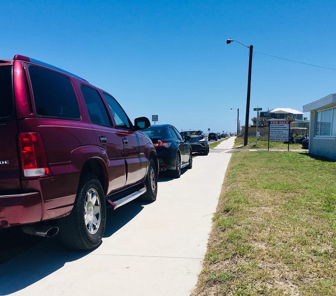 Cars in Flagler Beach parked on the sidewalk. [Photo provided by the Flagler Beach Police Department Facebook Page]