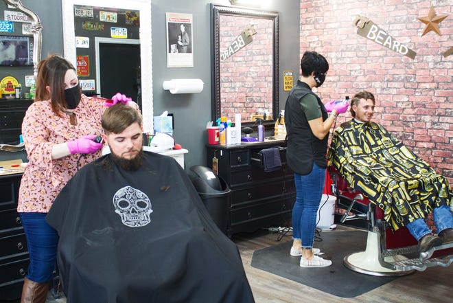 Barbers at Amy’s Vintage Barber Shop in Rincon are are wearing masks and gloves, switching their capes, washing their hands and “just being cautious.” [RICK LOTT/FOR EFFINGHAM NOW]