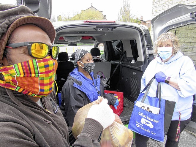 Prinston Martyn (left), food educator for Local Matters, and Kori Russell (middle), executive chef of Local Matters, use the Veggie Van to deliver food to the Broad Street Presbyterian Church food pantry. Accepting the delivery is food pantry director Kathy Kelly-Long.