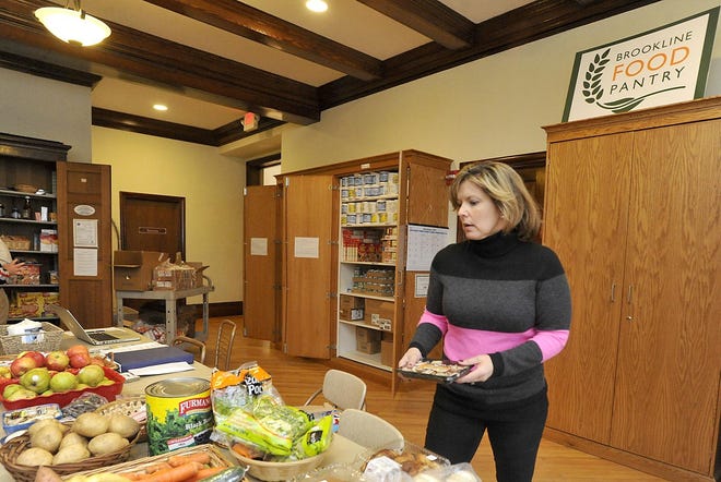 Former Brookline Food Pantry Executive Director Rene Feuerman sorts donations in a 2013 file photo. [Wicked Local File Photo/Keith E. Jacobson]