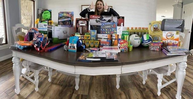 Jalyce Clark displays the loot she donated to the Christian Children's Home in Wooster. Clark raised the funds to procure the items via a fundraiser inspired by her involvement in National Honor Society.