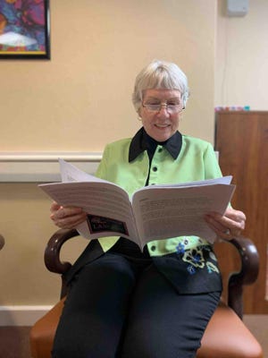 Kay Jones, a resident of Topeka Presbyterian Manor, reads pen pal letters sent by Landon Middle School students. About 75 letters from Landon students already have been delivered to Presbyterian Manor residents, and about 50 more letters will be delivered soon. [Submitted]