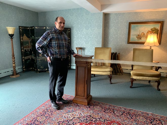 Funeral director Arthur Magni, of Andrew J. Magni & Son Funeral Home, at 365 Watertown St., stands in a private viewing room. Chairs for mourners are placed several feet apart and are located behind a ribbon to ensure social distancing. [Wicked Local staff photo/Julie M. Cohen]