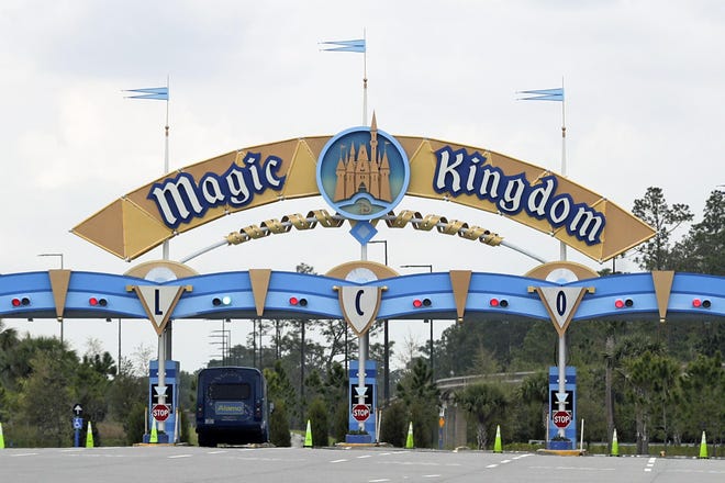 The entrance to the parking lot at the Magic Kingdom at Walt Disney World is closed Monday, March 16, 2020, in Lake Buena Vista, Fla. Epcot and Hollywood Studios were closed along with other theme parks around the state to help curb the spread of the coronavirus. (AP Photo/John Raoux)