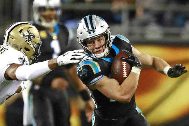 Carolina's Christian McCaffrey, right, tries to run past New Orleans' Marcus Williams in the second half of the team’s 2018 meeting in Charlotte. [AP Photo/Jason E. Miczek, File]