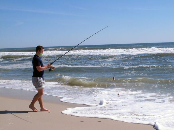 Mike Burdick, of Pemberton, prepares to cast a line into the surf at Island Beach State Park in New Jersey on May 2. [AP Photo/Wayne Parry]