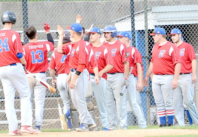 Cambridge Post 84 teammates exchange high-fives with Gavin Thompson (13) following his home run during a game with Marietta last season at Don Coss Stadium.