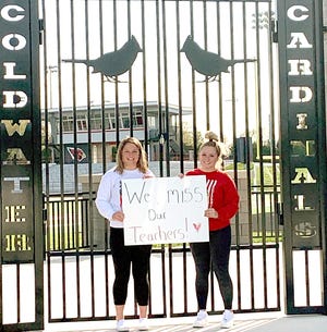 Mia Rzepka and Jadan Haylett, Coldwater High School students, send message many students are feeling — they miss their teachers. [Photo provided]