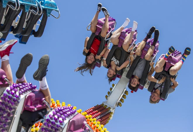 Fairgoers are twirled upside down by the El Nino on the first day of the Lane County Fair on July 18, 2018. The fair runs Wednesday through Saturday 11am to 11pm and Sunday 11am to 8pm. [Ben Lonergan/The Register Guard] - registerguard.com