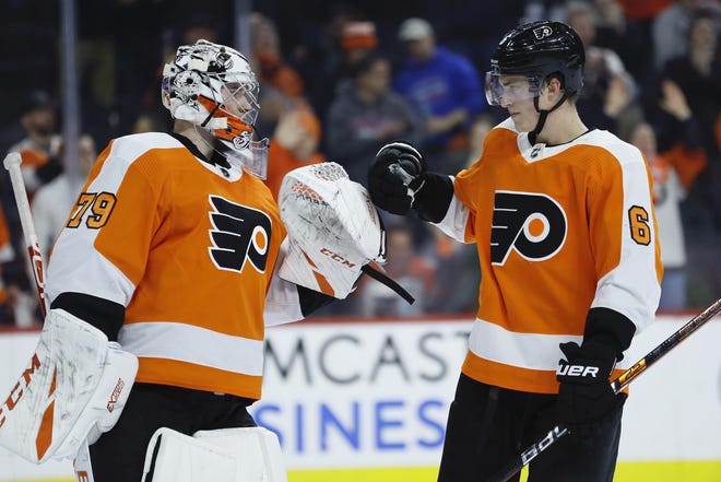 Philadelphia Flyers' Carter Hart, left, and Travis Sanheim celebrate after a game against Florida in February. [AP Photo/Matt Slocum]