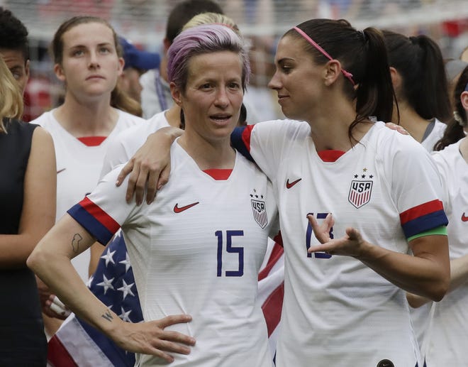 United States' Megan Rapinoe (left) talks to her teammate Alex Morgan (right) after winning the Women's World Cup final soccer match against Netherlands at the Stade de Lyon in Decines, outside Lyon, France. Players for the U.S. women's national team may have been dealt a blow by a judge's ruling in their gender discrimination case against U.S. Soccer, but the case is far from over. On Friday a federal judge threw out the players' unequal pay in a surprising loss for the defending World Cup champions. But the judge allowed aspects of their allegations of discriminatory working conditions to go to trial. [AP File Photo/Alessandra Tarantino]