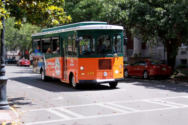 An Old Town Trolley tour takes a group of sightseers through downtown Savannah on Friday, May 8. The company resumed limited operations on Friday with 40 seat trolleys that have been limited to 10 to 12 people. Hand sanitizer dispensers have also been installed on all of the trolleys and each trolley is disinfected overnight and cleaned between each tour. [Margarita Bourke/ForSavannahNow.com]