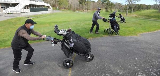 Masked and ready, golfers Sal Bonanno, left, Roger Cadrin, and Steve Iannotti head to see the firt tee at Hyannis Golf Course on Friday, May 8.

[STEVE HEASLIP/CAPE COD TIMES]