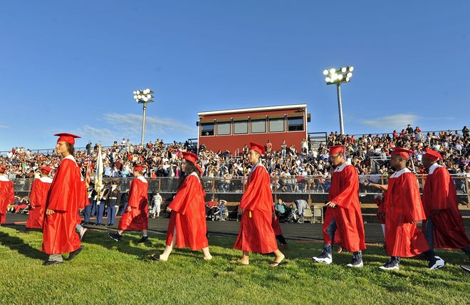 Students march onto Walsh Field for graduation at New Bedford High in 2019. The 2020 graduation ceremony has been scheduled for Aug. 13 at Walsh Field. [DAVID W. OLIVEIRA/STANDARD-TIMES SPECIAL/SCMG]