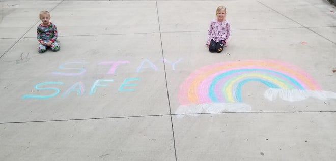 Julia and Jett Snyder, of Cambridge, decided to send a message to the community by creating a drawing in their driveway.