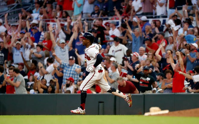 FILE - In this July 4, 2019, file photo, Atlanta Braves' Ozzie Albies rounds first base after hitting a three-run home run during the third inning of the team's baseball game against the Philadelphia Phillies in Atlanta. Major League Baseball owners gave the go-ahead Monday, May 11, 2020, to making a proposal to the playersâ€™ union that could lead to the coronavirus-delayed season starting around the Fourth of July weekend in ballparks without fans, a plan that envisioned expanding the designated hitter to the National League for 2020. (AP Photo/John Bazemore, File)