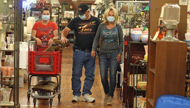 Kit Thompson with her dog “Pas Tue La” shops with Michael Ellefson and Lydia Tipton Monday afternoon, May 11, 2020, inside Catawba River Antique Mall in Belmont. [Mike Hensdill/The Gaston Gazette]