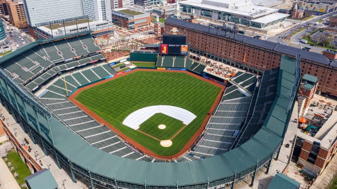 In this Thursday, March 26, 2020, file photo, Oriole Park at Camden Yards is closed on what would've been Opening Day in Baltimore, Md. A person familiar with the decision tells The Associated Press that Major League Baseball owners have given the go-ahead to making a proposal to the players’ union that could lead to the coronavirus-delayed season starting around the Fourth of July weekend in ballparks without fans. [Steve Helber/AP File Photo]