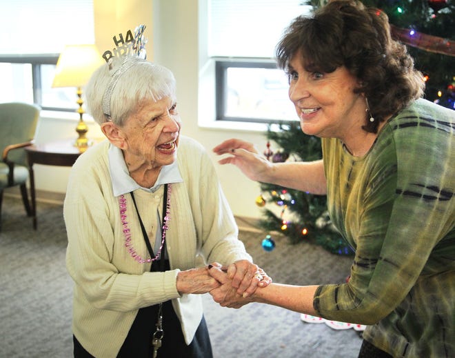 American Girls Baseball League icon Mary Pratt dances with Linda Dinneen as she celebrates her 99th birthday at 1000 Southern Artery, in Quincy, with a party, Thursday, Nov. 30, 2017. 

Gary Higgins/The Patriot Ledger
