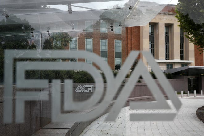Food and Drug Administration (FDA) signage is seen through a bus stop at the U.S. Department of Health and Human Services, Thursday, Aug. 2, 2018, in Silver Spring, Md., on the FDA grounds. (AP Photo/Jacquelyn Martin)