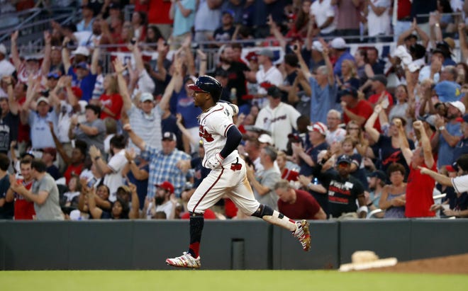 Atlanta Braves second baseman Ozzie Albies rounds first base after hitting a three-run home run against the Philadelphia Phillies on July 4, 2019, in Atlanta. [John Bazemore/The Associated Press]
