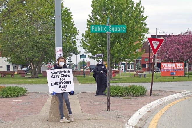 Demonstrators mainly from the Peoria area representing PETA were in Monmouth Wednesday to speak out against Smithfield Foods reopening amid the coronavirus pandemic. [JANE CARLSON/REGISTER-MAIL]
