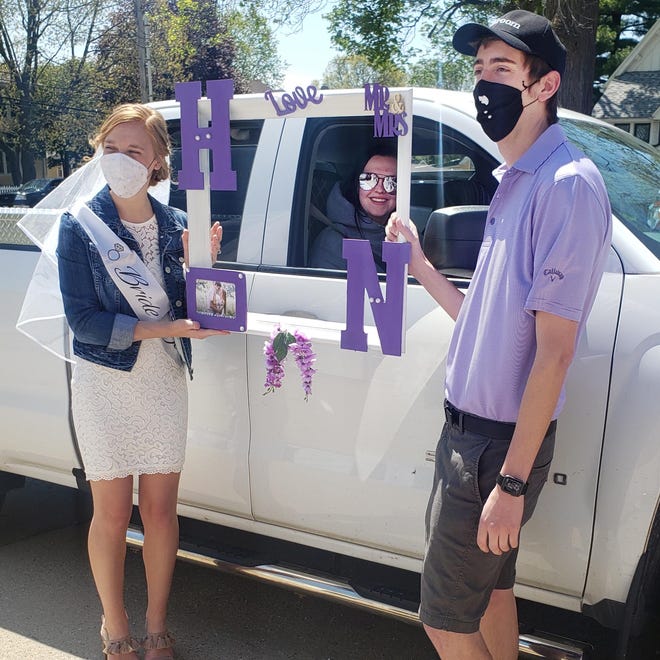 The bride, Hope Hammitt, and the groom, Nate Wager, greeted guests at their Chestnut Street drive-by wedding shower on Saturday. The couple will marry on June 6 at St. Ambrose University in Davenport. [Submitted]