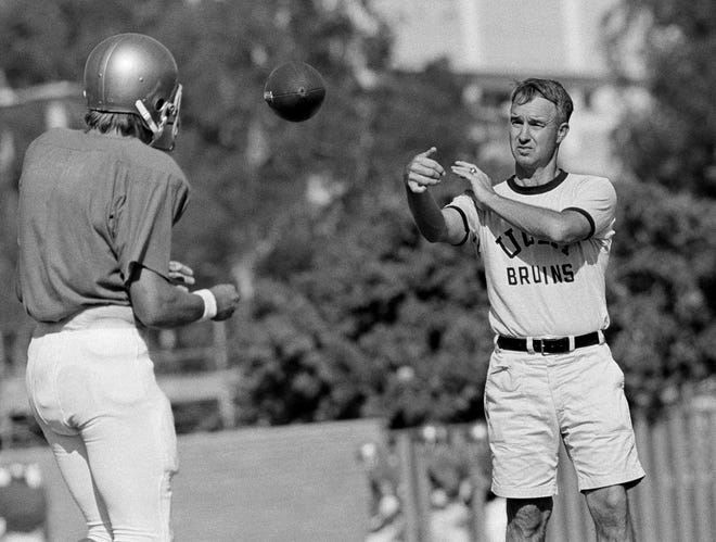 UCLA quarterback Mark Harmon, left, works out with coach Pepper Rodgers on Sept. 13, 1972 in Los Angeles. [AP FILE PHOTO]