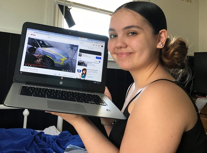 Shalynn Woicik, a junior in Diman Regional's auto collision shop, checks out a relevant video on YouTube. [Submitted photo]