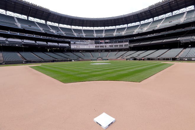 Second base sits in its place in an otherwise empty ballpark where grounds crew members continue to keep the Seattle Mariners' field in playing shape as the ballpark goes into its seventh week without baseball played because of the coronavirus outbreak Monday, May 11, 2020, in Seattle. A person familiar with the decision tells The Associated Press that Major League Baseball owners have given the go-ahead to making a proposal to the players' union that could lead to the coronavirus-delayed season starting around the Fourth of July weekend in ballparks without fans. (AP Photo/Elaine Thompson)
