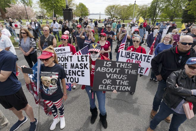People demonstrate Saturday against state restrictions imposed over concern about COVID-19 near the residence of Gov. Charlie Baker in Swampscott, Mass. [AP Photo/Michael Dwyer]