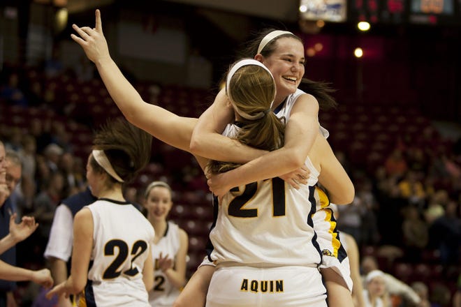 Sophie Brunner (21) and Katie Stykel share a hug after Aquin won their second straight state title in 2013, a day after edging Annawan 39-38 in what has been picked as the second-greatest girls basketball game in area history. [BEN WOLOSZYN/ROCKFORD REGISTER STAR]