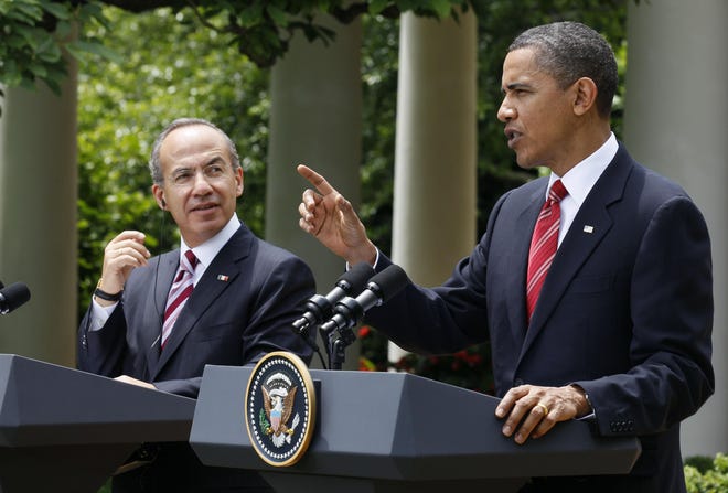 President Barack Obama and Mexican President Felipe Calderon participate in a joint news conference in the Rose Garden of the White House on May 19, 2010, in Washington. [Alex Brandon/The Associated Press]