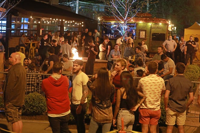 A crowd gathers to drink on the patio of Standard Hall, a bar in Columbus' Short North Art District on Friday, May 15, 2020 about 11 p.m. [Doral Chenoweth/Dispatch]