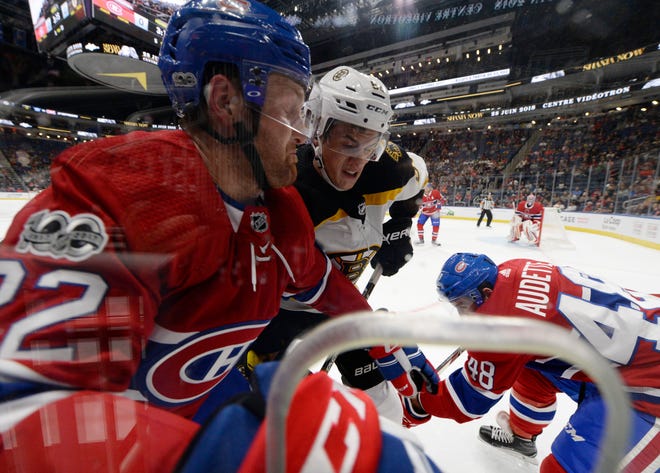 Bruins rookie forward Jack Studnicka battles the Canadiens’ Karl Alzner, left, and Daniel Audette during a preseason game in 2017. Studnicka's first professional season has been a rousing success. He led his team in most offensive categories, and led his league in one of them. He played in an All-Star game, and was named to an All-Rookie team. He made his big-league debut, and scored a point. Now he's hoping his season isn't over despite the rest of the AHL season being canceled. [USA TODAY Sports, file / Eric Bolte]