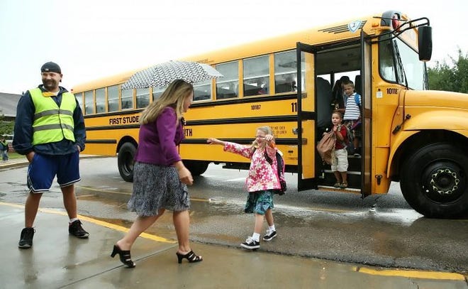 Melville Elementary School Principal Liz Viveiros greets Trinity Brosnahan on the first day of school in 2013. [DAILY NEWS FILE PHOTO]