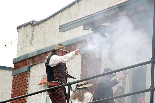 A mock gunfight was an element of a skit presented Saturday afternoon on the balcony of the Historic Whiting Hotel. The character in the photo was seeking vigilante justice. Belle Starr and the Indian Territory Pistoliers performed the skit. Robert Smith/Journal-Capital
