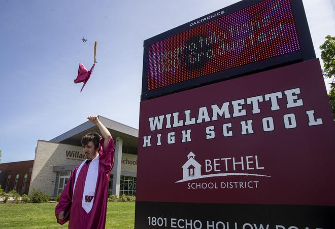 Willamette High School senior Carston Dodson tosses his cap in the air as he poses for Christi Cameron as Dodson has his picture taken outside the school Friday to celebrate his achievement. The staff at the school is trying to make the best of the situation by honoring each of the graduates as they pick up their diplomas. Seniors will continue to pick up their diplomas this week. [Andy Nelson/The Register-Guard] - registerguard.com
