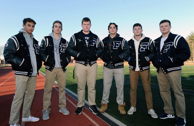 Framingham High School football captains from left: Andrew Keane, Jack Beverly, Brad Woodhouse, Brad Bogovich, Reece LaChance and Nick Novello pose for a picture on Nov. 26, 2019 at Natick High before the Flyers' annual Thanksgiving Day game against Natick. [Daily News and Wicked Local Staff File Photo/Art Illman]
