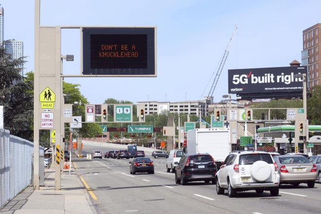 A state government sign reminds drivers ‘Don’t Be A Knucklehead’ and instead practice social distancing during the coronavirus pandemic in Jersey City, New Jersey on Wednesday. [AP Photo/Ted Shaffrey]