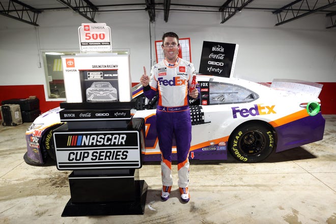 Denny Hamlin, driver of the No. 11 FedEx Toyota, celebrates in victory lane after winning the rain-shortened NASCAR Cup Series race at Darlington Raceway on May 20. [CHRIS GRAYTHEN/GETTY IMAGES]
