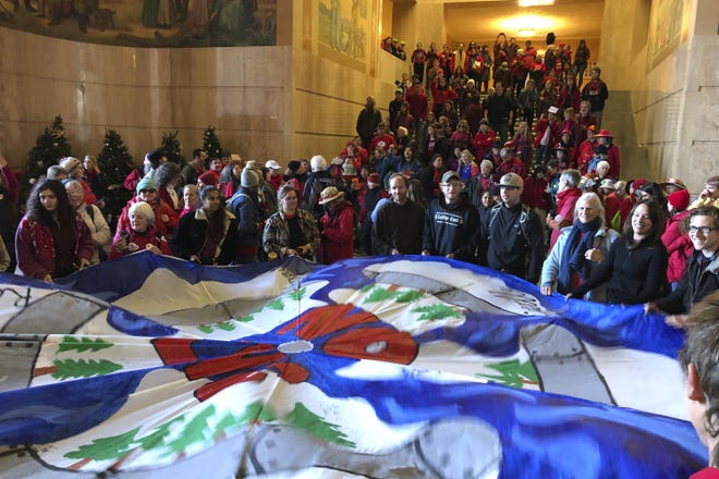 Demonstrators against a proposed liquid-natural gas pipeline and export terminal in Oregon flooded into the State Capitol in November 2019. [Andrew Selsky/The Associated Press]