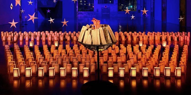 In a new WaterFire art installation titled Beacon of Hope, a nightly ceremony celebrates and commemorates the lives lost in the state, as luminaria are displayed in an otherwise pitch black industrial room, one set out for every person who has died from the disease.