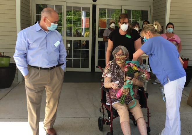 Ipswich resident Martha Dupray receives flowers and cards from Masconomet Healthcare Center staff as she's released after being treated for COVID-19. [Wicked Local Photo / Wendall Waters]