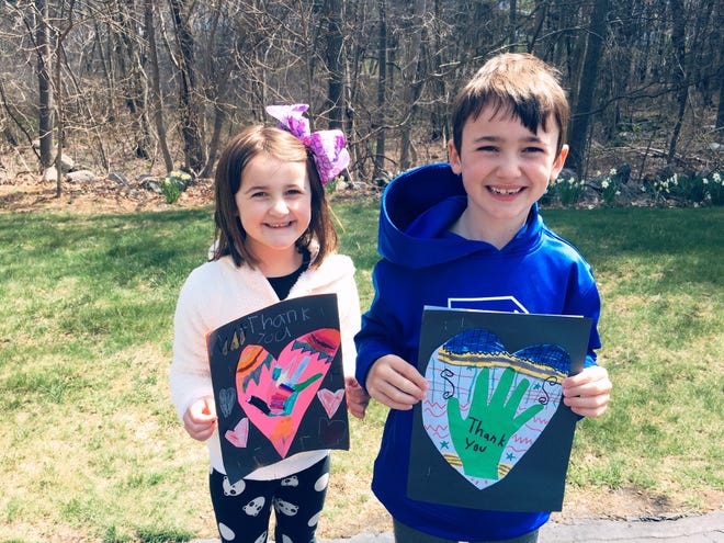 Juliana and Connor Appleton with the thank you cards they made for first responders.